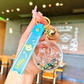 Close-up of blue bunny moon liquid glitter keychain with milk and candy rubber wristlet - Black Luminous Bubble Bead Star Moon Rabbit