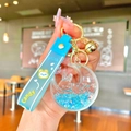 Macro detail of blue liquid quicksand star rabbit keychain with silicone wrist strap - Blue Luminous Bubble Bead Star Moon Rabbit