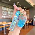 Close-up of blue liquid glitter shaker charm with silicone wristband and gold keychain - Blue Luminous Bubble Bead Coke Can