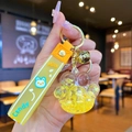 Detailed view of cat paw liquid quicksand keychain with glitter and yellow milk strap - Yellow Luminous Bubble Bead Cat Paw