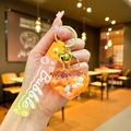 Detail of orange heart-shaped liquid quicksand keychain with gold bell and bubble strap - Gradient Strap Orange Snowflake Heart