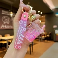 Detailed view of a pink bubble tea keychain with liquid quicksand and gold bell - Pink Luminous Bubble Bead Milk Tea Cup