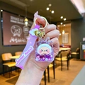 Detail of purple cartoon liquid sand keychain with Sweet Heart strap and gold bell - Purple Cloud Rope