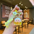 Yellow unicorn keychain featuring transparent resin charm with gold sequins and bell - Yellow Cloud Rope
