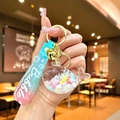 Detail of creative whale liquid quicksand keychain with blue-pink gradient strap and bell - Gradient Rope [white] Glow-in-the-dark Snowflake Whale