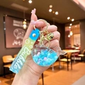 Handheld liquid whale keychain with blue gradient sand and a golden bell accessory - Gradient Rope [blue] Glow-in-the-dark Snowflake Whale