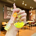 Macro shot of whale liquid sand keychain with yellow glitter, bell and wristband - Gradient Rope [yellow] Glow-in-the-dark Snowflake Whale