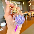 Purple lollipop keychain with floating star sequins and a golden bell charm hanging - Noctilucent Purple Lollipop