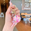 Lollipop-shaped keychain with pink resin, dried flowers, and golden bell charm - Pink Snowflake Lollipop