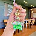 Star-shaped liquid quicksand keychain with colorful beads and small gold bell charm - Green Colorful Bead Pentagram