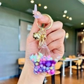 Star-shaped liquid sand keychain with purple and pink candy beads and gold bell - Purple Colorful Bead Pentagram