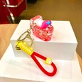 Detalle del llavero My Melody con bañera de purpurina y correa de silicona roja suave - Inodoro De Pvc Rojo Que Brilla En La Oscuridad