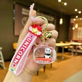 Close-up of a panda liquid keychain with pink silicone wristband and golden bell - Panda TV / Red