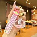 Close-up of pink acrylic floating panda keychain with glitter and gold bell charm - Panda TV / Pink