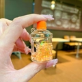 Close-up of a mini orange water bucket keychain with sparkling glitter and star sequins - Luminous Bubble Beads Bucket (Without Keychain) / Orange