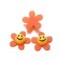 Detail of orange acrylic sunflower beads with smiley faces for DIY hair accessories - Orange (29x29mm)