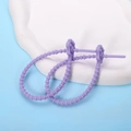 Close-up of purple silicone cat paw cable ties on a white stone base with blue background - Cat Paw / 2 Pcs/Set / Purple