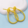 Close-up of yellow silicone cable ties with flower buckles on a white stone pedestal - Plum Blossom / 2 Pcs/Set / Yellow
