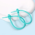 Close-up of mint green silicone cable tie earrings with star detail on white stone - Pentagram / 2 Pcs/Set / Cyan