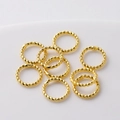 Close-up of textured 18K gold plated twisted rings for DIY jewelry making supplies. - 1x6mm (20 Pieces/Pack) / 18K Gold Plated Color Retention Closed Ring