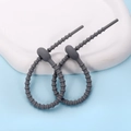 Close-up of gray silicone cable ties with non-slip bead design on a white tray - Ellipse / 2 Pcs/Set / Gray