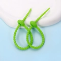 Detail of two lime green flexible silicone cable ties with adjustable bead buckle design - Ellipse / 2 Pcs/Set / Green