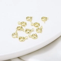 Detailed view of 18K gold-plated spring ring clasps for DIY jewelry on a white plate - 5mm/Aperture 1.1mm / 14K Color-Preserving Real Gold (2 Pieces)