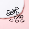 Macro shot of black heart-shaped open jump rings with textured matte finish for DIY jewelry - 12x14mm/Thickness 1.5mm (50 Pieces/Pack) / Black