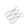Close-up of white braided PU leather keychains with polished silver metal rings - 5 Pieces / White
