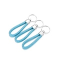 Close-up of three hand-woven light blue PU leather keychains with silver metal rings - 5 Pieces / Sky Blue