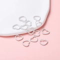 Macro shot of white matte heart-shaped jump rings for DIY handmade jewelry connecting - 12x14mm/Thickness 1.5mm (50 Pieces/Pack) / White