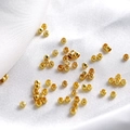 Macro shot of polished 18K gold plated copper spacer beads for DIY jewelry making - 1.2*2.0mm (100 Pieces) / 18K Gold