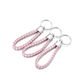 Close-up of pink and white braided PU leather keychains with silver metal rings - 5 Pieces / Pink White
