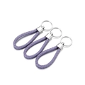 Detailed close-up of purple woven PU leather keychains with polished silver metal rings - 5 Pieces / Light Purple
