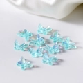 Macro shot of light blue aurora resin butterflies for DIY nail art and jewelry making - Blue