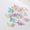 Macro shot of 12 Aurora AB resin butterflies for DIY nail art and jewelry making - Multicolor