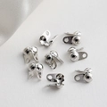 Close-up of silver-plated ball chain end clasps and fold-over crimp covers for jewelry making - 2*3.3*4.9mm (Aperture 0.8mm) / White K/Silver