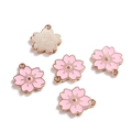 Detail view of pink enamel cherry blossom charms with rose gold metal back for DIY crafts - 10 Pieces/Pack (17.8*19.7mm / 1.9mm Hole Size) / Pink