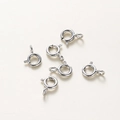 Detail shot of six silver spring ring clasps for jewelry making in high-quality finish - White Gold
