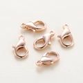 Five rose gold lobster clasps for DIY jewelry making laid on a textured beige surface - 5x10mm (301) / Rose Gold Plated