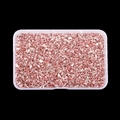 Detailed macro shot of rose gold crushed glass stones in a clear plastic storage box - Pink