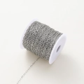 Macro shot of silver oval link chain roll for DIY jewelry making and necklaces - White Gold