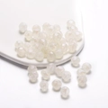 Macro shot of iridescent multifaceted acrylic beads on a white ceramic tray for DIY jewelry - Pearlescent Polyhedron / 10mm (30 Pieces/Pack) / White