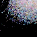 Macro detail of multi-sized iridescent glass bubble beads for DIY nail art and resin crafts - Macarons