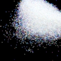 Macro shot of 20g iridescent AB micro glass beads for DIY nail art and resin crafts - 0.8-1mm Iridescent Transparent
