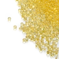 Macro shot of iridescent golden glass bubble beads for DIY nail art and craft filling - Yellow