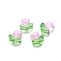 Detailed macro view of semi-transparent tulip glass beads with pink petals and green leaves - Flat Pink