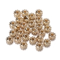 Close-up of golden CCB gear-shaped spacer beads with central hole for DIY jewelry making - Gear Shape / 100pcs Pack / KC Gold