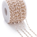 Detail of pink crystal square beads and gold metal beads chain on a spool for DIY jewelry - Cream Colored (KC Gold Chain)