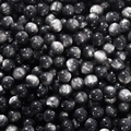 Macro shot of black cat-eye resin round beads with silver sheen for DIY jewelry making - Black